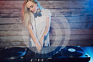 Cute dj woman having fun playing music at club party