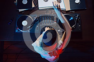 Cute dj woman having fun playing music at club party