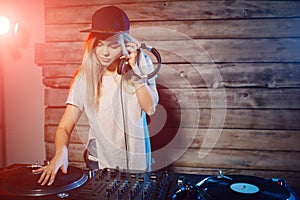 Cute dj woman having fun playing music at club party