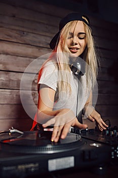 Cute dj woman having fun playing music at club party