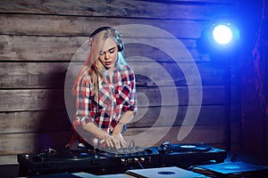 Cute dj woman having fun playing music at club party