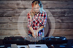 Cute dj woman having fun playing music at club party