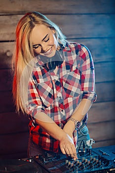 Cute dj woman having fun playing music at club party