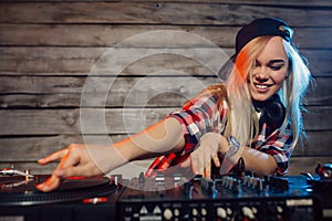 Cute dj woman having fun playing music at club party