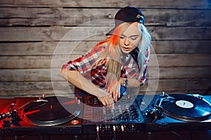 Cute dj woman having fun playing music at club party