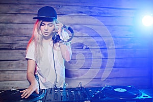 Cute dj woman having fun playing music at club party