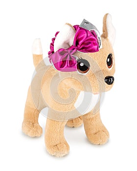 Cute dog doll with pink ribbon isolated on white background with shadow. Playful bright brown dog sitting on white underlay.