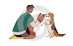 Cute dog giving high five with paw to hand. Pet owner and doggy communication, man and canine animal relationship