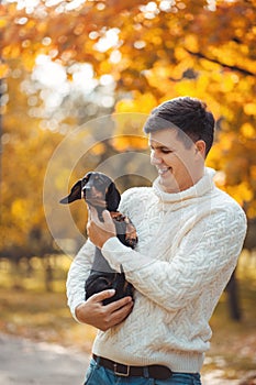 Cute dog and his owner have fun in the park