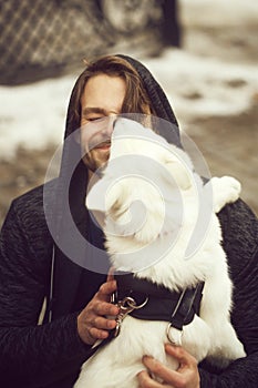 Cute dog licking face of happy doggy man