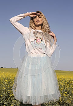 Cute doll look. White and blue romantic dress over blue sky.