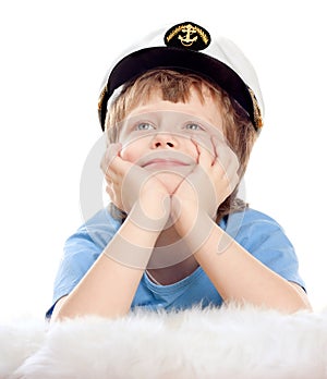 Cute dreaming child in captain cap