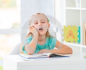 Cute dreaming little girl at school