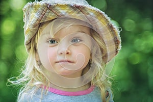 Cute dreamy little girl in funny hat