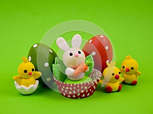Cute easter baby bunny and chicks toys on a green background stock images