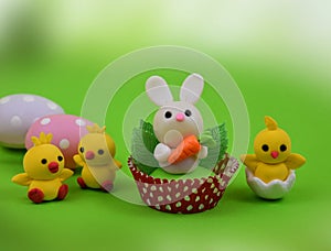 Cute easter baby bunny and chicks toys on a green background stock images