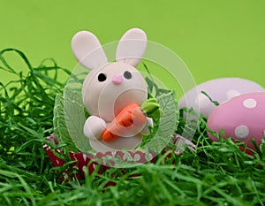 Cute easter baby bunny toy on a green background stock images