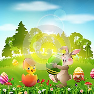 Cute Easter bunny holding an egg with little chick in cracked eggshell