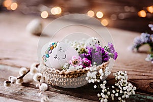 Cute sleeping Easteregg on rustic wooden background with cozy lights photo