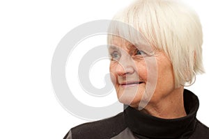 Cute elderly woman looking at copyspace