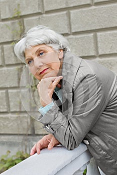 Cute elderly woman senior on the verandah