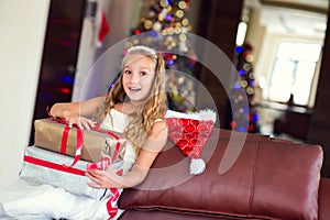 Cute elegant girl celebrate Christmas and New Year with presents