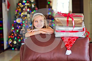 Cute elegant girl celebrate Christmas and New Year with presents