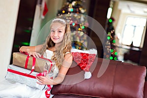 Cute elegant girl celebrate Christmas and New Year with presents