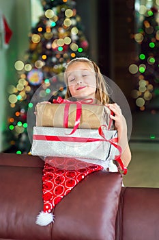 Cute elegant girl celebrate Christmas and New Year with presents