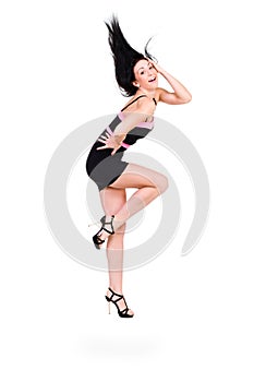 Cute elegant woman in black dress jumping