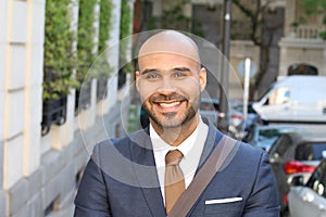 Cute ethnic bald man wearing a suit
