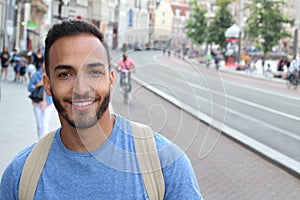 Cute ethnic bearded man smiling outdoors