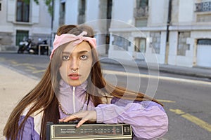 Cute ethnic woman holding a boombox