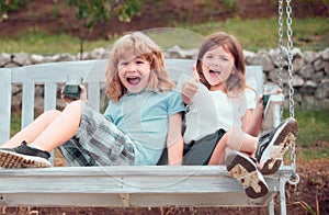 Cute excited amazed little children playing outdoors. Portrait of two happy young kids at the spring park. Cute lovely