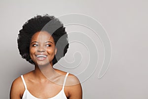 Cute excited surprised young woman brunette looking adide on white studio wall background