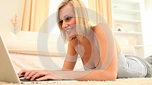 Cute fairhaired woman using her laptop