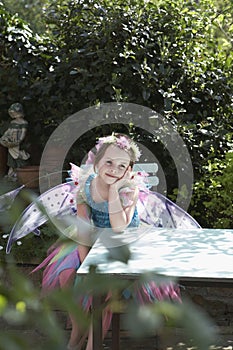 Cute Fairy Girl At Garden Table