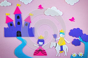 Cute fairy tale scene in felt with a princess and a prince in love in front of a fantasy castle