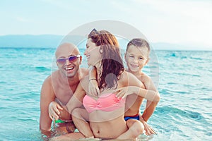 Cute Family on the beach having fun together