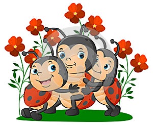 The cute family of the ladybugs with the son and girl are hugging her mother