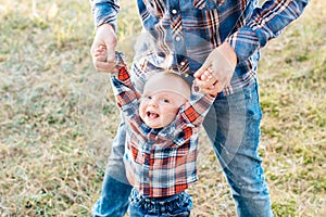 A cute family - mom, dad and son spend fun time outdoors in a beautiful pine forest