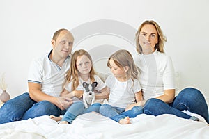 Cute family relax together at home smiling and hugging