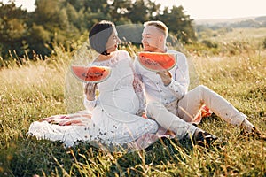 Cute family spending time in a summer field