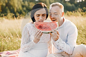 Cute family spending time in a summer field