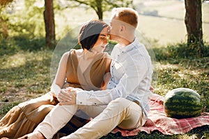 Cute family spending time in a summer field