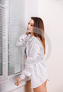 Cute fashionable young woman wearing a white mens shirt.