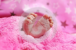 Cute feet of newborn baby on the blanket. The concept of love, health and care