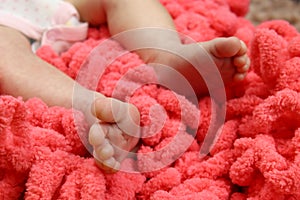 Cute feet of newborn baby on the blanket. The concept of love, health and care