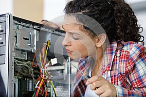Cute female engineer at home working on technology