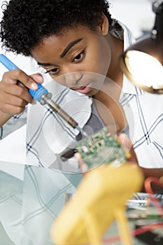cute female engineer at home working on technology